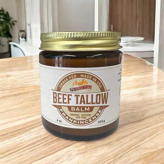 Grass fed beef tallow balm jar with frankincense on a wooden table in a modern room