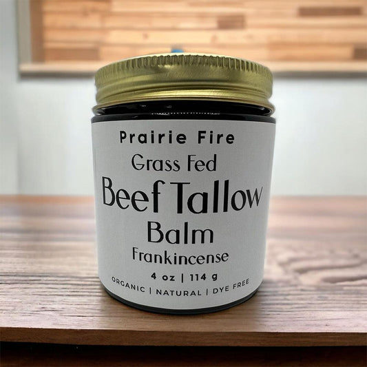 Grass fed beef tallow balm jar with frankincense on wooden table, organic and natural skincare