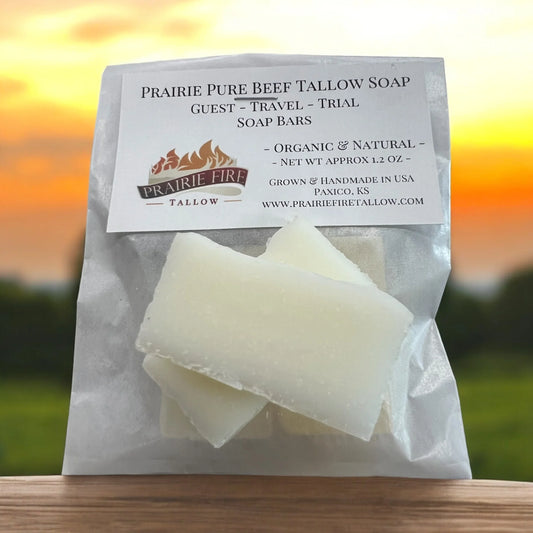 Pure beef tallow soap bars in a labeled package on a wooden surface with a sunset background.