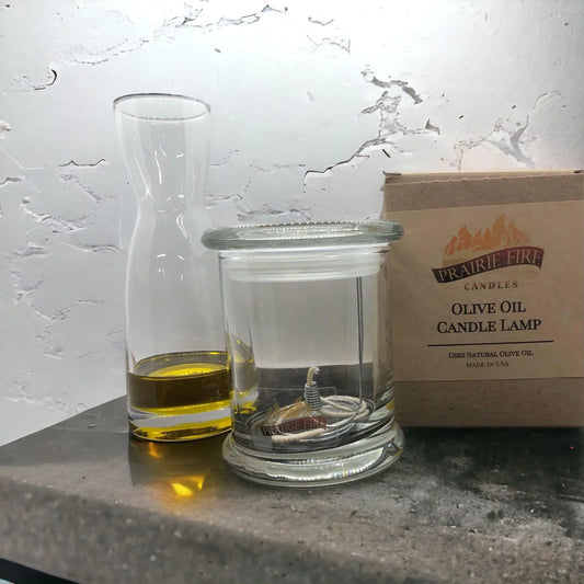 Olive oil candle lamp kit with a clear jar, wick, and olive oil, for emergency use