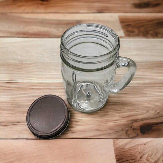 Glass mason jar with handle and metal lid on wooden surface
