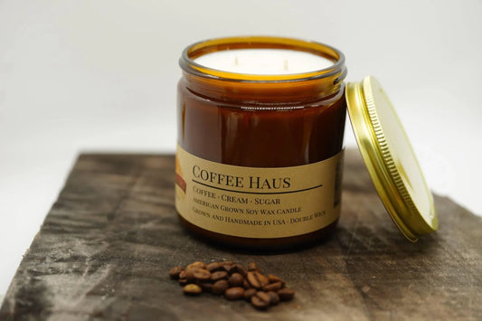 Coffee Haus soy wax candle in amber jar with double wick and coffee beans on wood surface