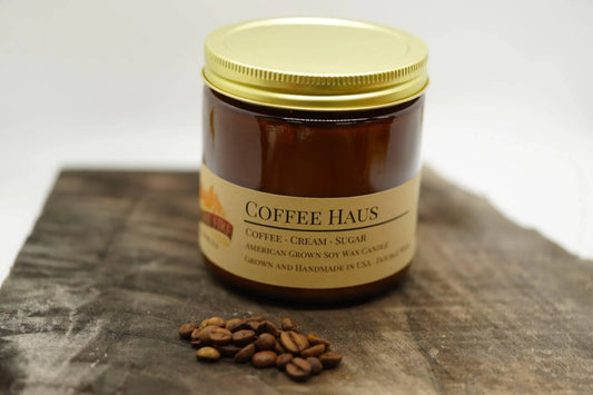 Amber jar Coffee Haus soy wax candle with gold lid and coffee beans on rustic wood