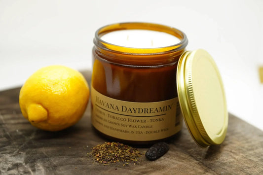 Amber jar Havana Daydreamin soy wax candle with lemon and spices on wood surface