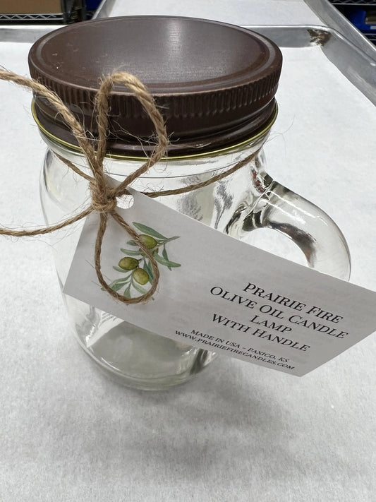 Glass mason jar olive oil candle lamp with handle and brown lid, tied with twine and label