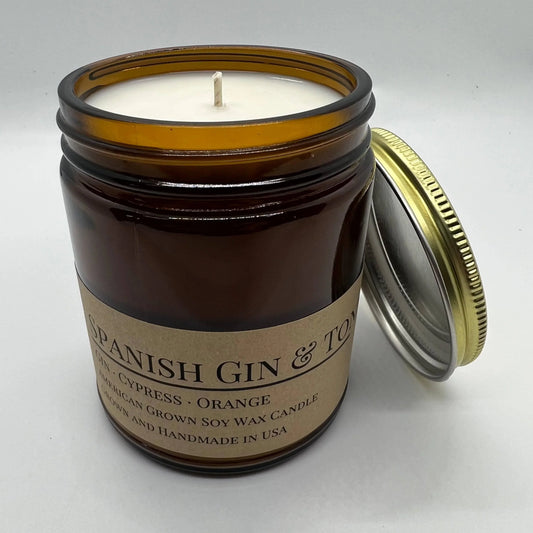 Soy wax candle in amber glass jar with cotton wick and metal lid, Spanish Gin & Tonic scent.