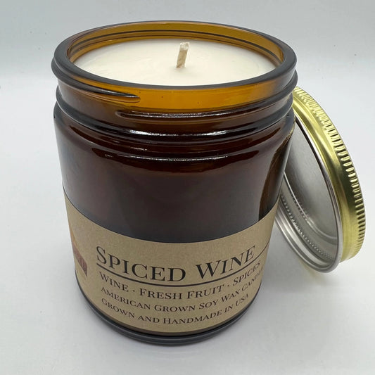 Spiced wine scented soy wax candle in amber glass jar with cotton wick and metal lid