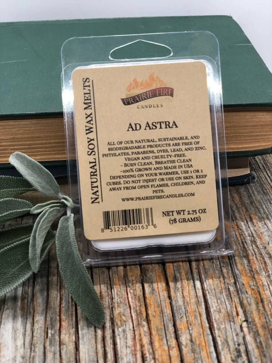 Natural soy wax melts in plastic packaging, labeled Ad Astra, on rustic wood with sage and books.