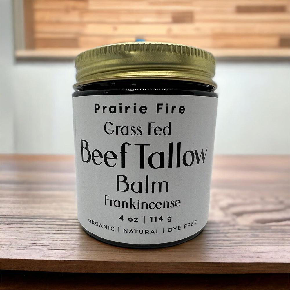 Grass fed beef tallow balm jar with frankincense on wooden table, organic and natural skincare